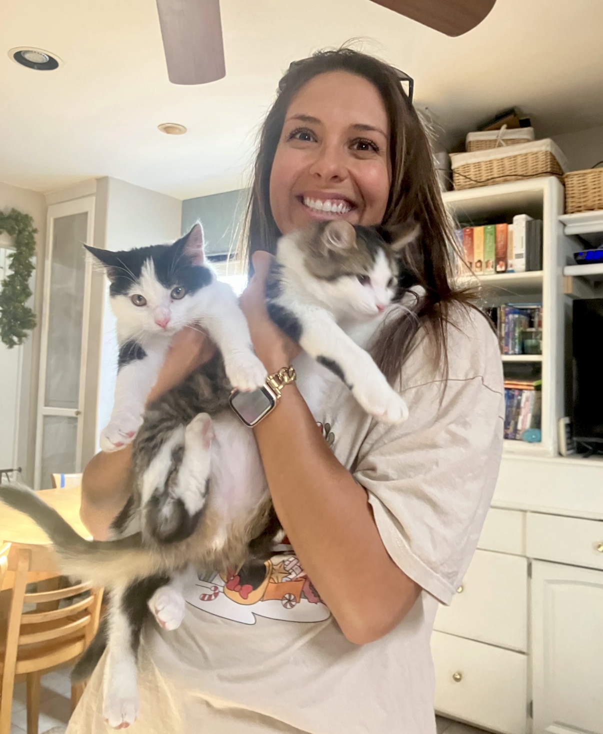 Kasandra Sabin smiling while holding two kittens